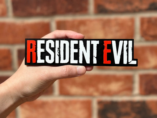 Logo 3D de Resident Evil con acabado mate y gran nivel de detalle para decoración de vitrinas, escritorios y zonas gaming.