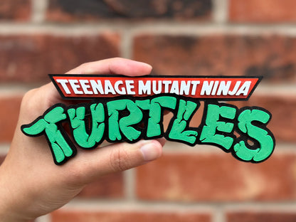 Logo 3D de Tortugas Ninja Mutantes Adolescentes con gran nivel de detalle para vitrinas, escritorios y zonas gaming.