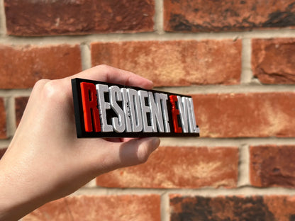 Logo 3D de Resident Evil con acabado mate y gran nivel de detalle para decoración de vitrinas, escritorios y zonas gaming.