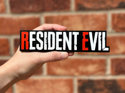 Logo 3D de Resident Evil con acabado mate y gran nivel de detalle para decoración de vitrinas, escritorios y zonas gaming.