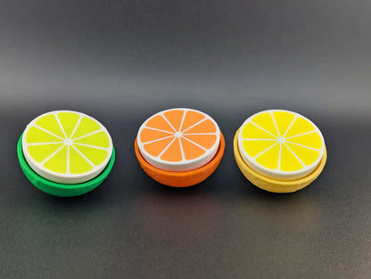 Clicker Cítrico impreso en 3D con diseño de rodaja de cítrico para aliviar el estrés y mantener las manos ocupadas.