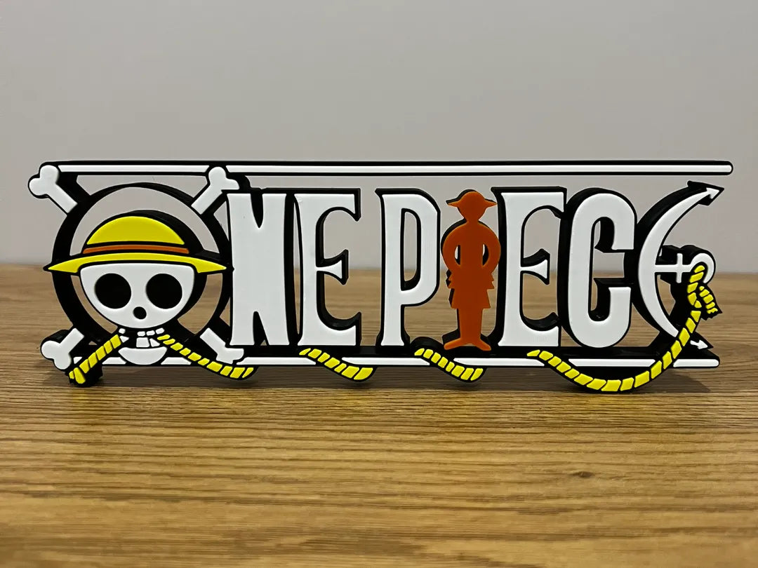 Logo 3D de One Piece con acabado mate y gran nivel de detalle para decoración de escritorios, vitrinas y espacios gaming.